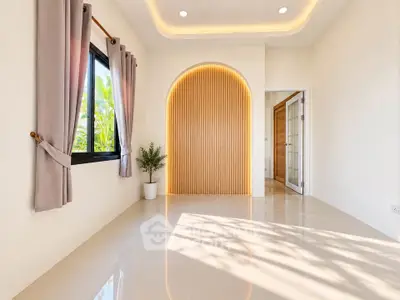 Bright and modern room with elegant lighting and large window, perfect for stylish living.
