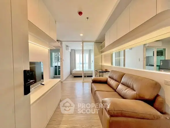 Modern living room with sleek design and cozy leather sofa in a bright apartment.