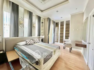 Luxurious bedroom with elegant decor and ample natural light in modern home.