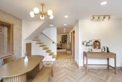 Modern open-plan living space with stylish wooden furniture and elegant lighting