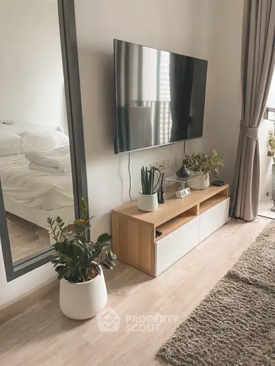 Modern living room with sleek TV setup and cozy decor