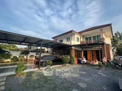 Spacious two-story house with carport and garden in serene neighborhood.