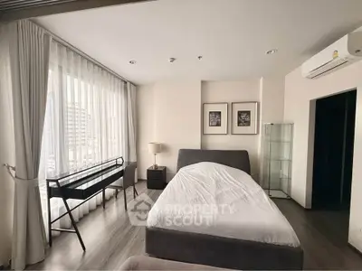 Modern bedroom with city view, featuring sleek furniture and natural light.