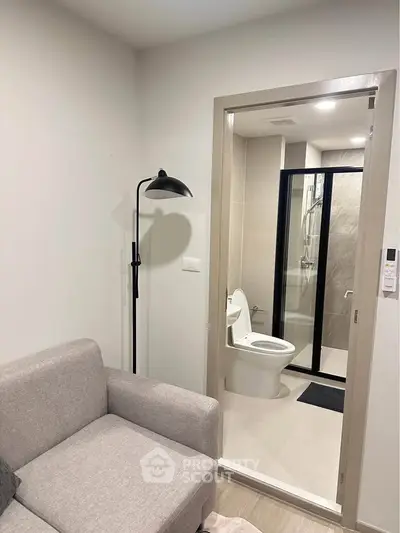 Modern apartment interior with cozy living area and sleek bathroom design.
