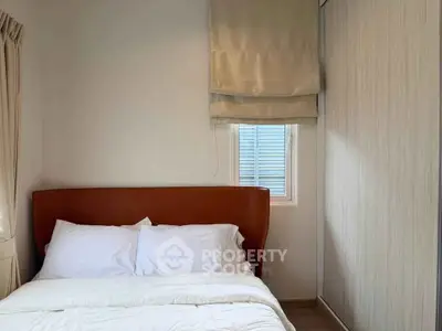 Cozy bedroom with plush bed and modern wardrobe, perfect for restful nights.