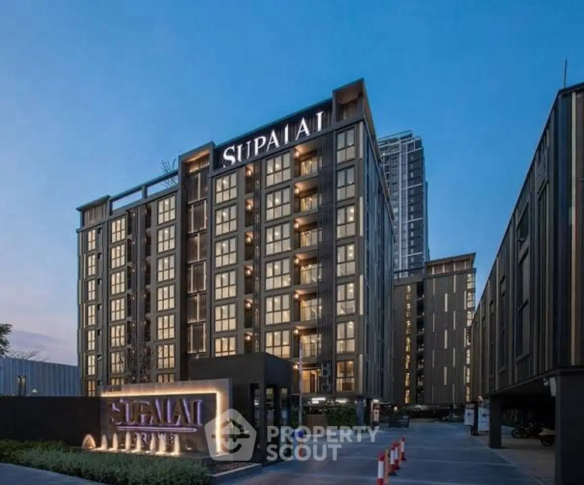 Modern residential building exterior with elegant facade and evening lighting.