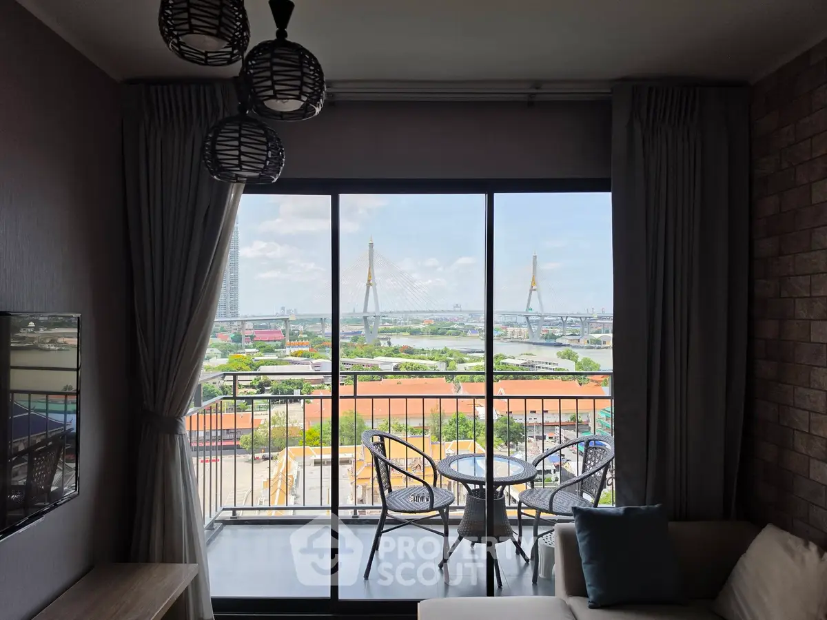 Stunning living room with balcony offering panoramic city and river views, perfect for relaxation and entertaining.