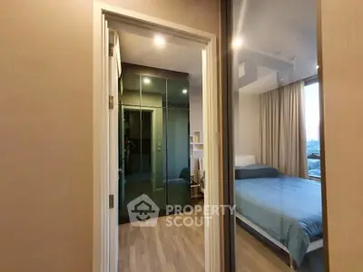 Modern bedroom with glass wardrobe and city view, featuring sleek design and cozy ambiance.