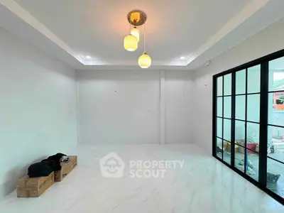 Spacious modern living room with elegant lighting and large glass doors