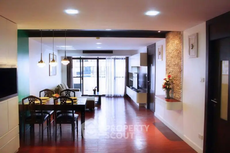 Spacious modern living room with dining area and large windows for natural light.