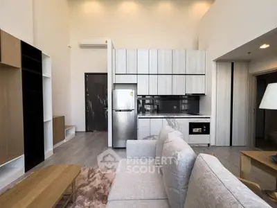 Modern open-plan living room with sleek kitchen and stylish furniture