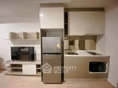 Modern kitchen with sleek cabinetry and integrated appliances in a stylish apartment.