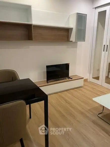 Modern living room with sleek furniture and wooden flooring