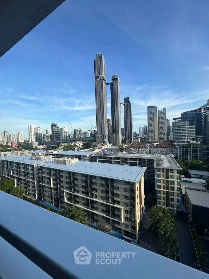 Stunning cityscape view from a high-rise balcony showcasing modern skyscrapers and urban skyline.