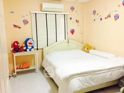 Charming bedroom with playful decor and cozy ambiance, perfect for relaxation.