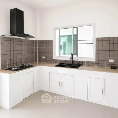 Modern kitchen with sleek design, featuring gas stove and ample cabinetry.