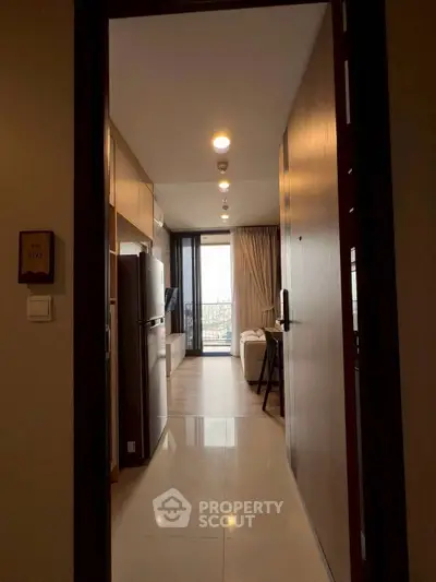 Modern apartment entrance leading to a cozy living area with a balcony view.