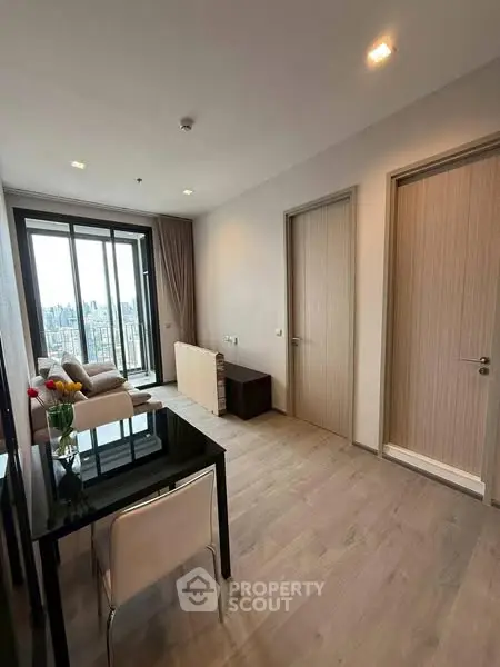 Modern living room with city view, sleek furniture, and elegant decor
