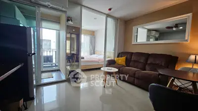 Modern living room with glass partition to bedroom and balcony access