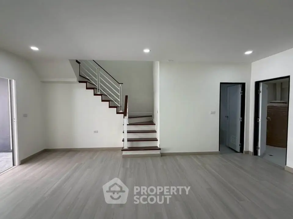 Spacious modern living room with sleek staircase and minimalist design