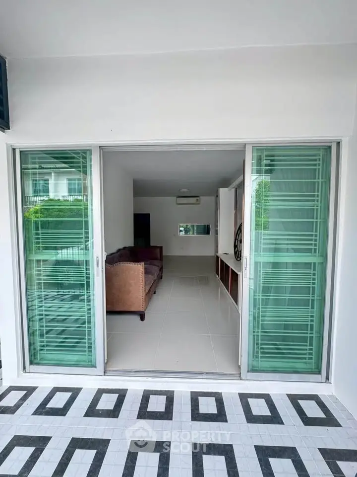 Modern living room with sliding glass doors and stylish tile flooring