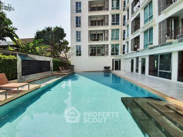 Luxurious apartment building with a stunning outdoor pool and modern design.