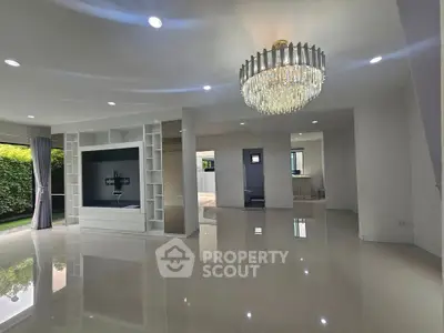 Spacious modern living room with elegant chandelier and glossy tile flooring