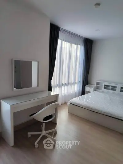 Modern bedroom with minimalist furniture and large window with curtains