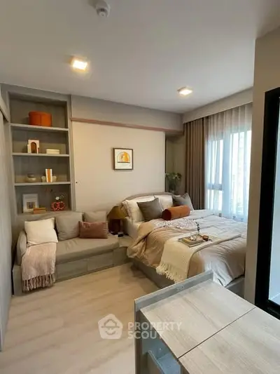 Modern bedroom with cozy decor and natural light in a stylish apartment.