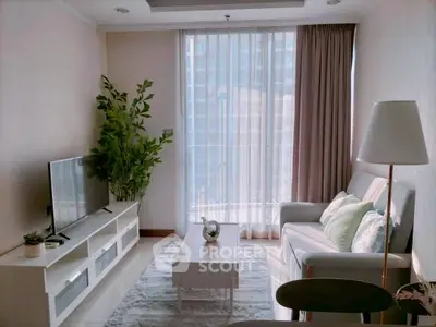 Bright and cozy living room with modern decor and large window view.