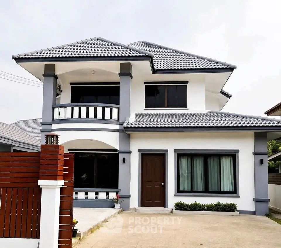 Modern two-story house with stylish roof and spacious driveway