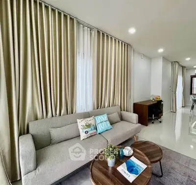 Modern living room with stylish sofa and elegant curtains, perfect for relaxation and entertaining.