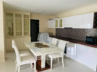Modern kitchen with elegant dining area and sleek cabinetry