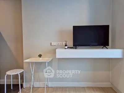 Modern minimalist living room with wall-mounted TV and sleek furniture