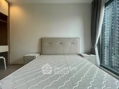Modern bedroom with large window and city view, featuring a stylish bed and elegant decor.