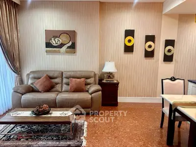 Elegant living room with leather sofa, stylish decor, and warm lighting, perfect for relaxation and entertaining.