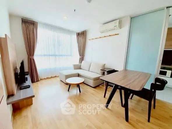 Bright and modern living room with wooden flooring and stylish furniture in a cozy apartment.