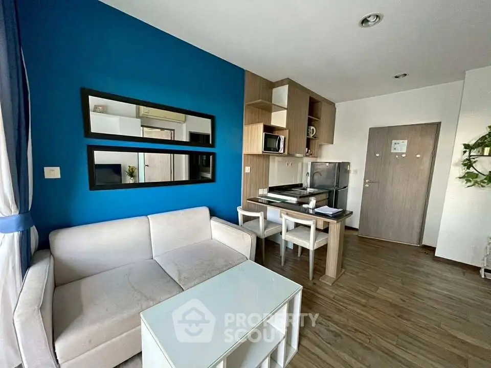 Modern living room with blue accent wall and cozy furniture