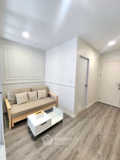 Modern living room with sleek wooden flooring and minimalist furniture design.