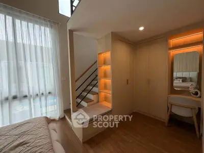 Modern bedroom with built-in storage and cozy seating area