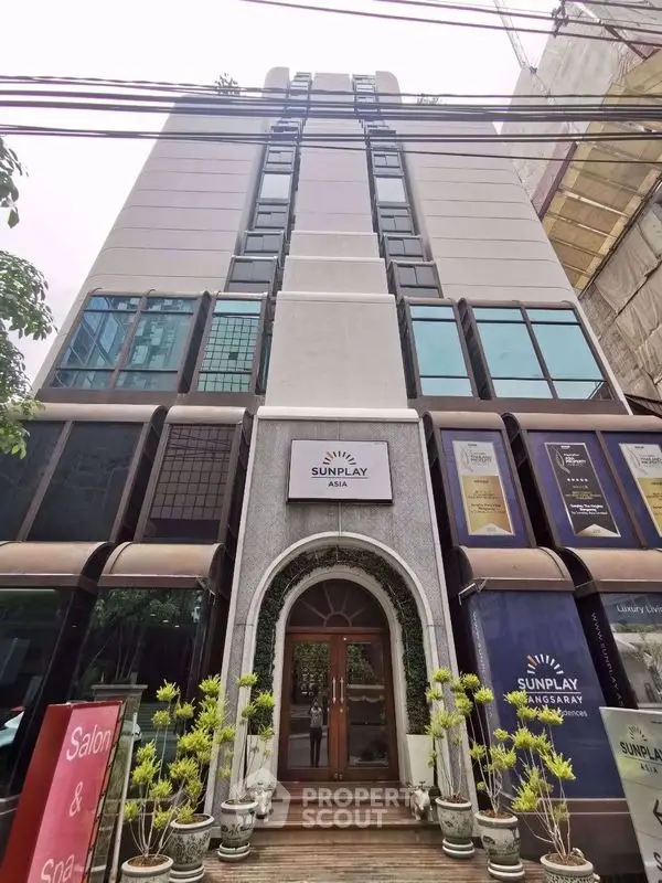 Modern commercial building with sleek glass facade and elegant entrance