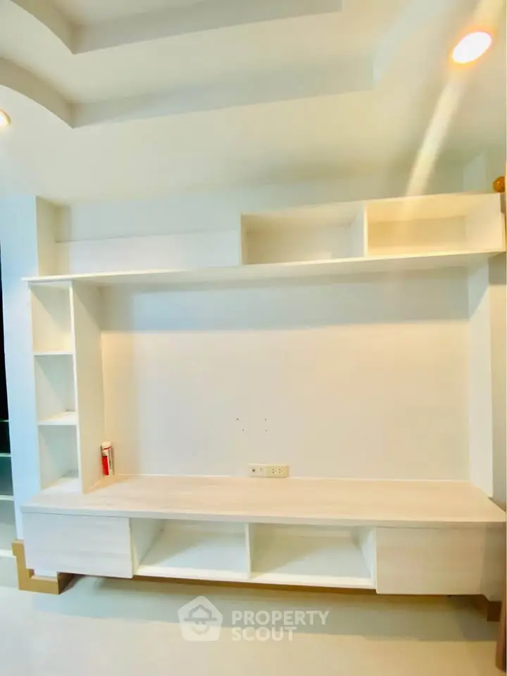 Modern built-in living room shelving unit with sleek design and ample storage space.