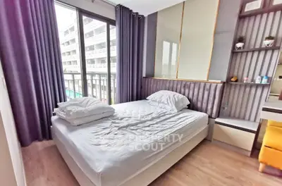 Modern bedroom with large window and stylish decor in urban apartment