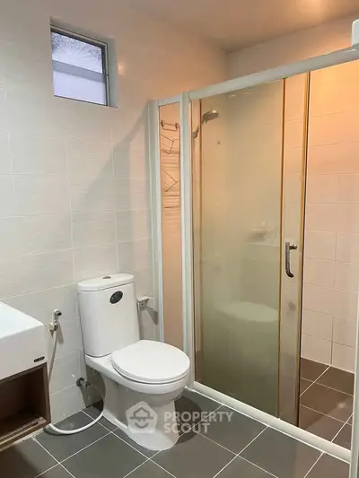 Modern bathroom with glass shower and sleek fixtures, perfect for contemporary living.