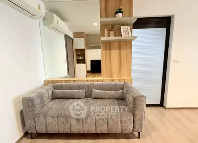 Modern living room with stylish gray sofa and wooden accents, perfect for cozy relaxation.