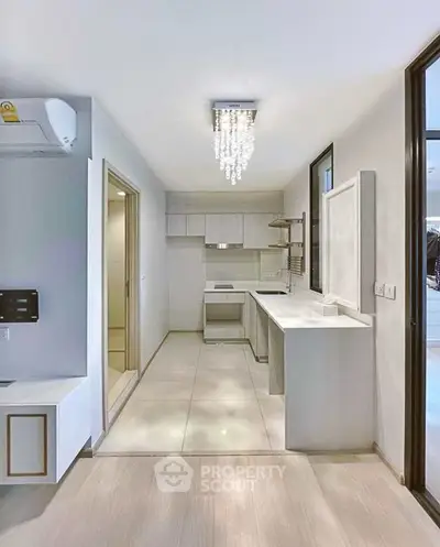 Modern kitchen with sleek design and elegant lighting in a contemporary apartment.