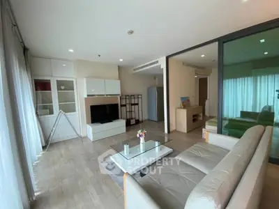 Spacious modern living room with sleek furniture and large windows for natural light.