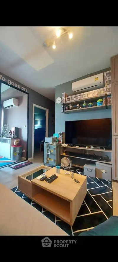 Modern living room with stylish decor and entertainment setup.