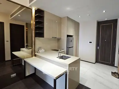 Modern kitchen with sleek cabinetry and built-in appliances in a stylish apartment.