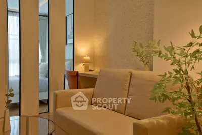 Modern living room with cozy beige sofa and stylish decor, perfect for relaxation and comfort.